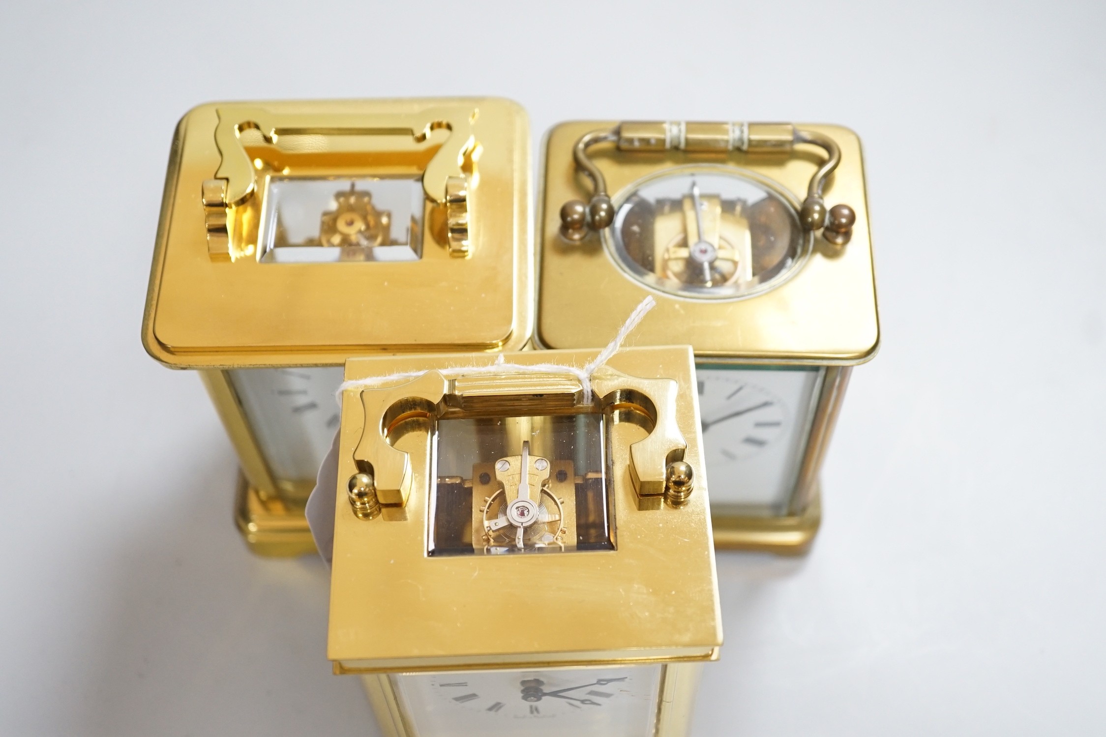 Two brass cased carriage timepieces and a brass cased carriage clock, tallest 11.5cms high